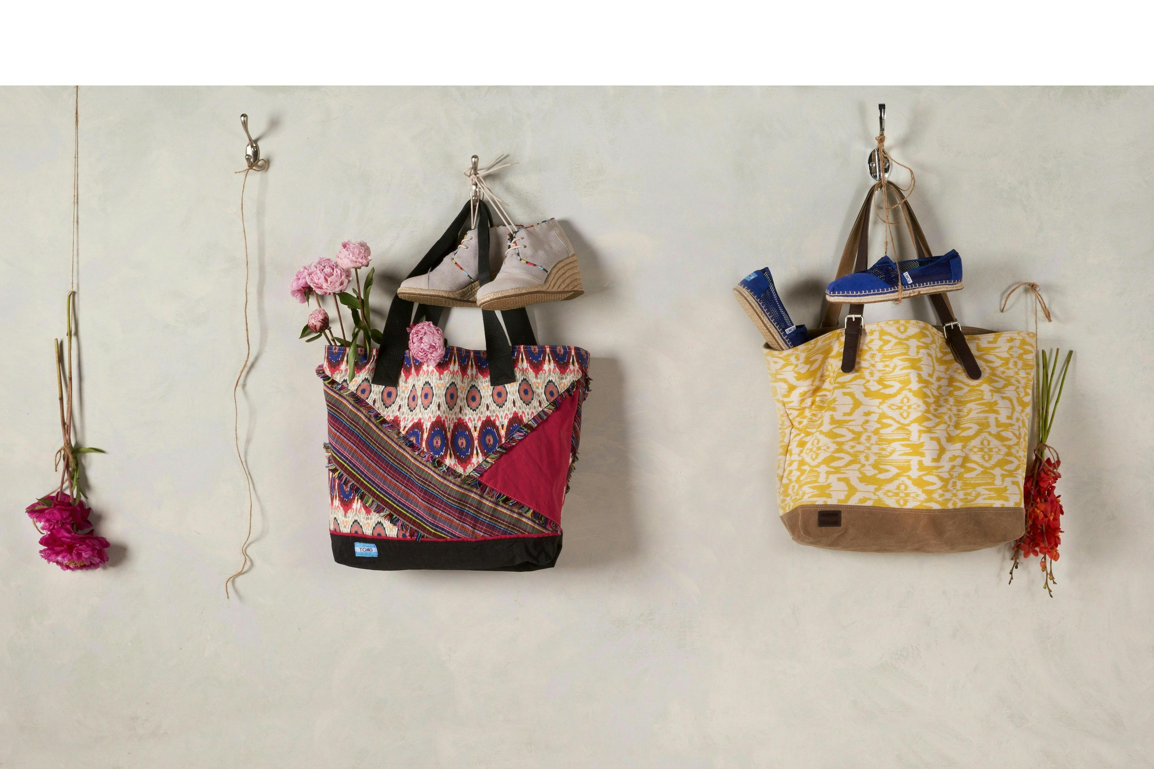 flat lay photography - colorful bags and toms shows hanging from string beside a rose