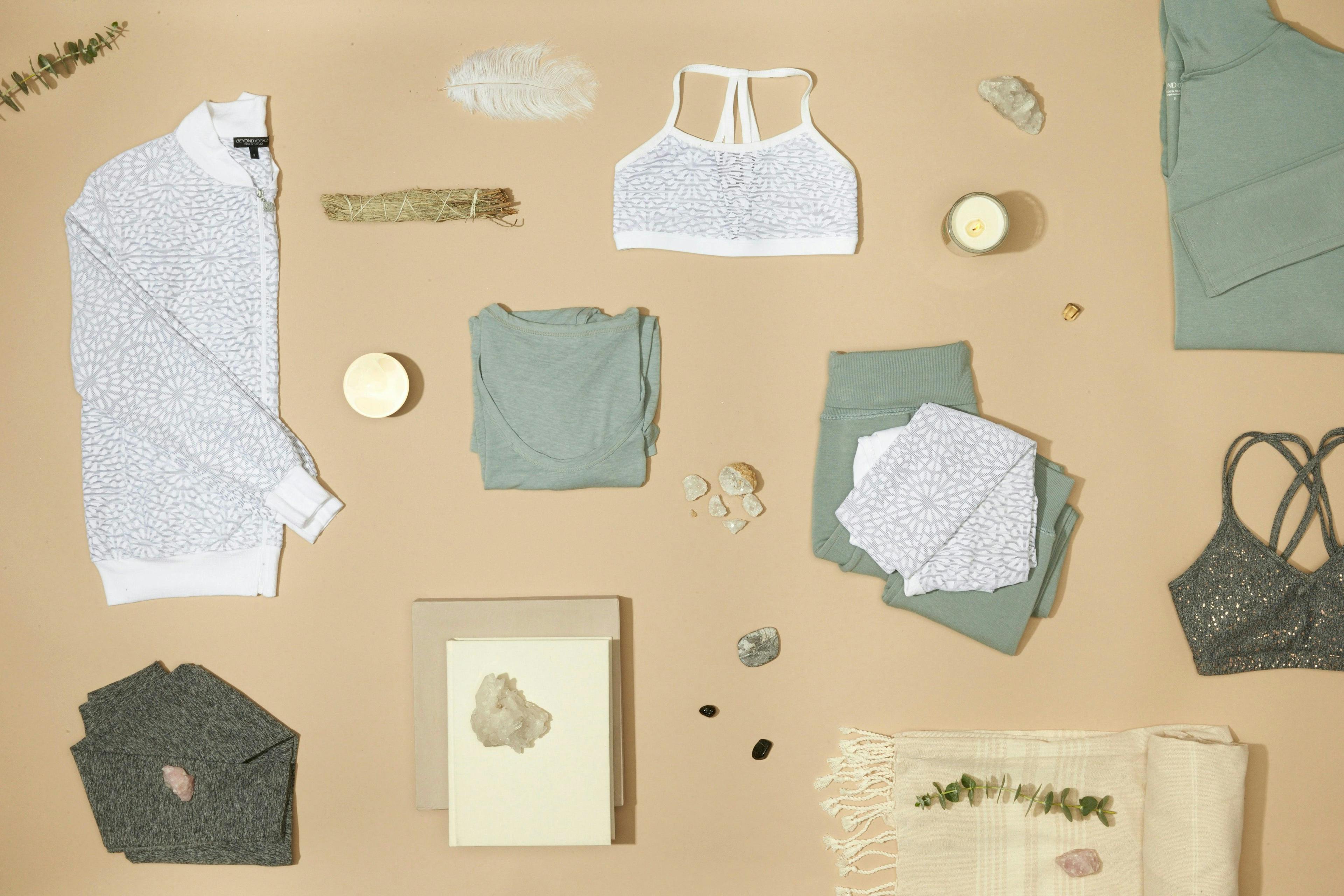 flat lay photography - yoga clothes on a table flat lay with various cool- toned accessories 