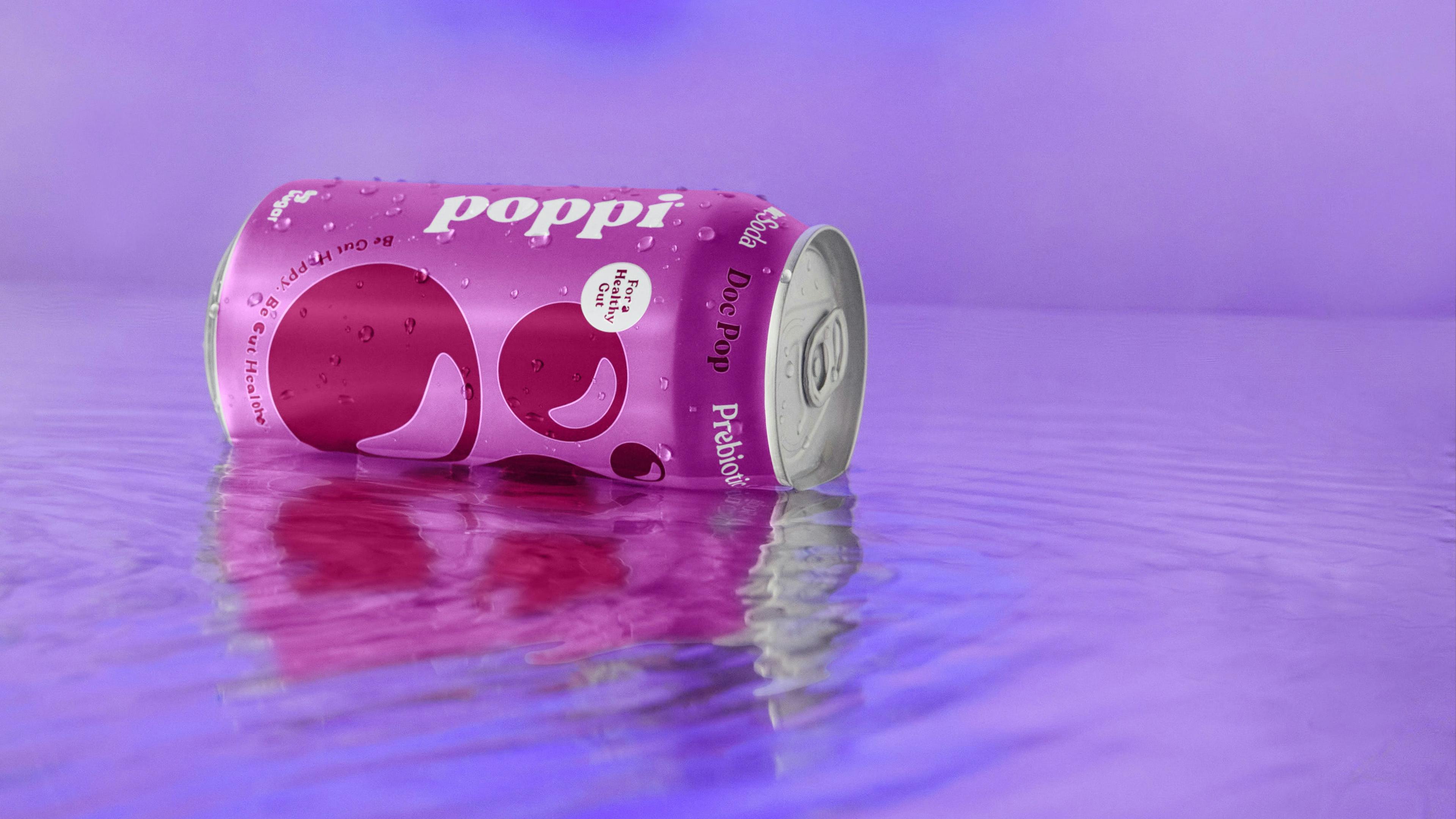 Close-up of a vibrant purple beverage can immersed in a transparent liquid, creating a captivating and colorful product photography composition